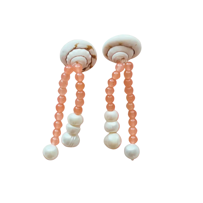 Pair of earrings with beads on a gradient orange background