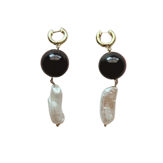 Pair of earrings with black and white stones on a gradient background