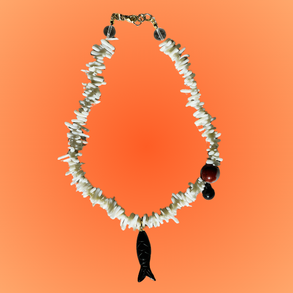 Necklace with black and white beads on an orange background