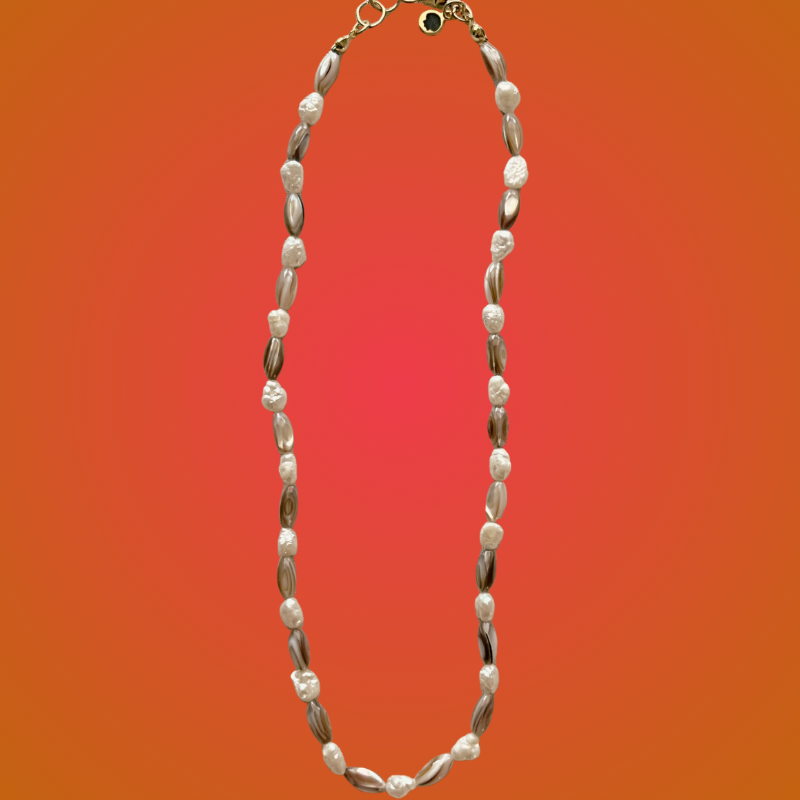 Necklace with shell-like beads on a gradient orange background