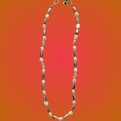 Necklace with shell-like beads on a gradient orange background