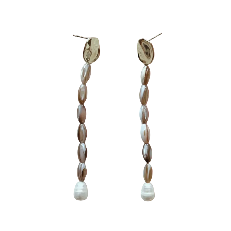Pair of beaded earrings on an orange gradient background