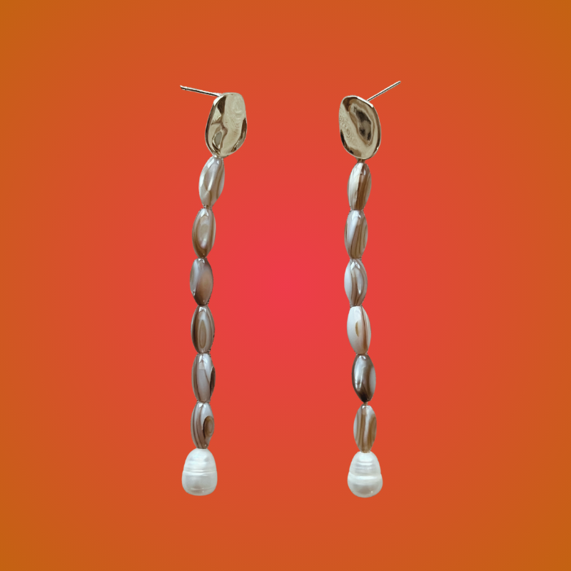 Pair of beaded earrings on an orange gradient background