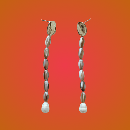 Pair of beaded earrings on an orange gradient background