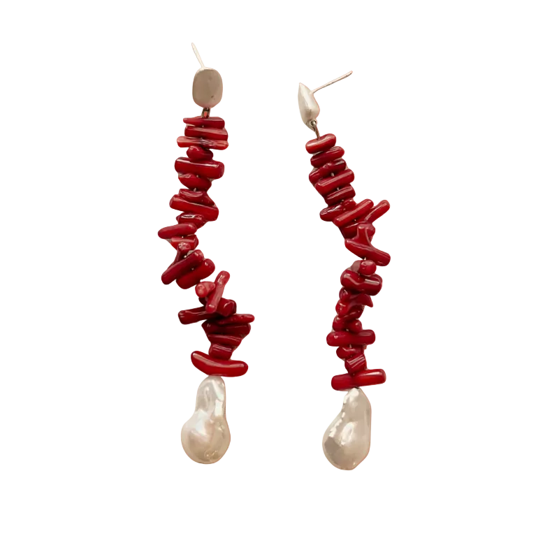 Red and pearl drop earrings on an orange gradient background