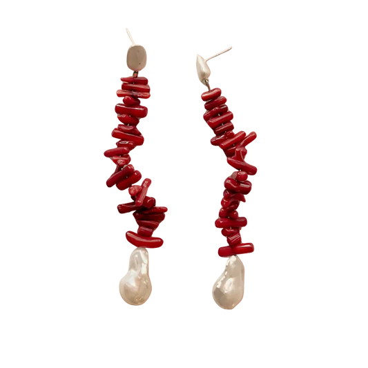 Red and pearl drop earrings on an orange gradient background