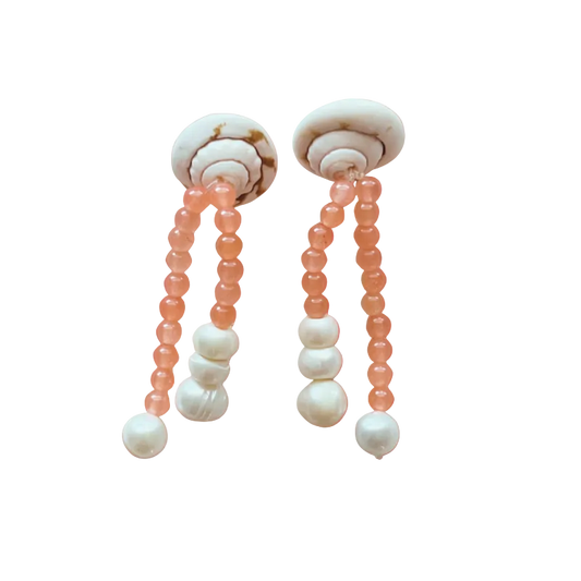 Pair of earrings with beads on a gradient orange background